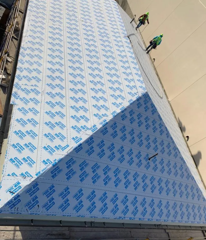 Professional roofers installing underlayment on a metal roof in Citrus Springs